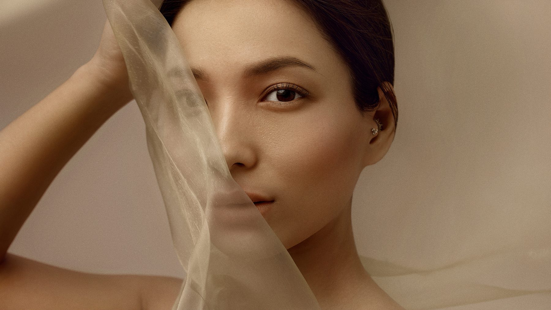 A face behind a warm sheer veil.